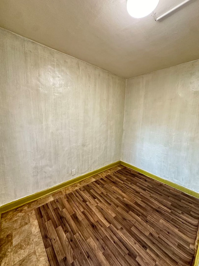 empty room featuring dark wood-type flooring