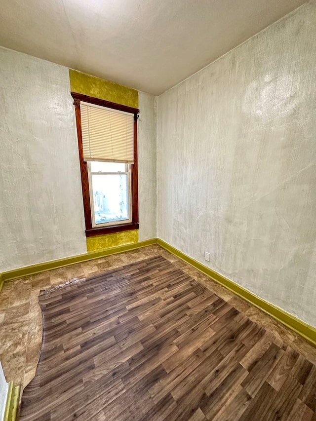 unfurnished room with dark wood-type flooring