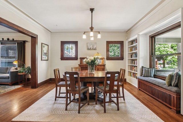 412 Pleasant St, Oak Park, IL 60302 - dining area featuring built in shelves, wood finished floors, and crown molding