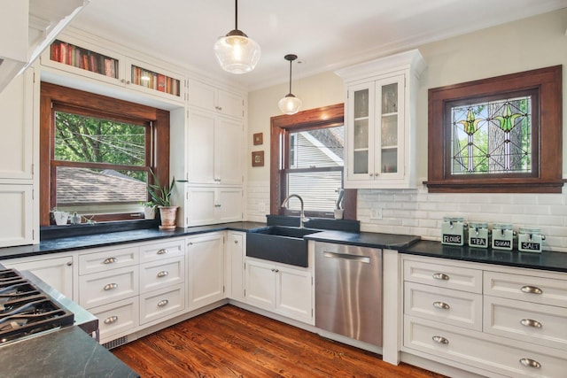412 Pleasant St, Oak Park, IL 60302 - kitchen with stainless steel dishwasher, dark countertops, decorative backsplash, white cabinets, and pendant lighting
