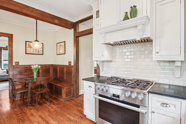 412 Pleasant St, Oak Park, IL 60302 - kitchen with high end range, decorative backsplash, white cabinets, wood finished floors, and crown molding