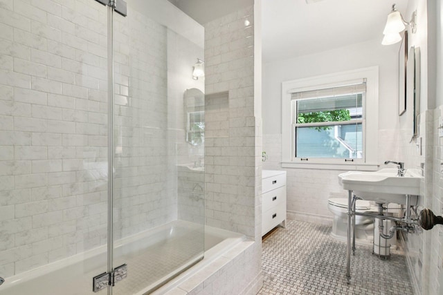 412 Pleasant St, Oak Park, IL 60302 - bathroom with tile walls, a tile shower, tile patterned floors, and tiled bath