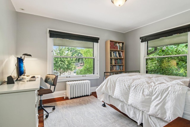 412 Pleasant St, Oak Park, IL 60302 - bedroom with radiator, multiple windows, wood finished floors, and an office area
