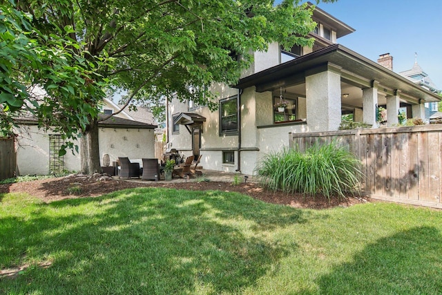 412 Pleasant St, Oak Park, IL 60302 - rear view of property featuring stucco siding, outdoor lounge area, and a chimney
