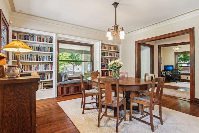 412 Pleasant St, Oak Park, IL 60302 - dining area featuring crown molding, a chandelier, wood finished floors, built in shelves, and radiator heating unit