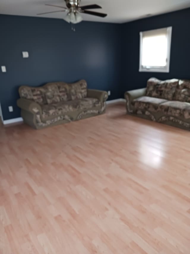 living room with ceiling fan and light wood-type flooring