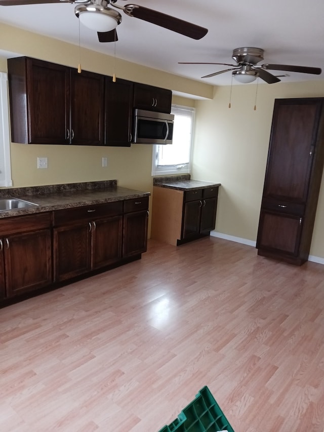 kitchen with light hardwood / wood-style floors, sink, and ceiling fan