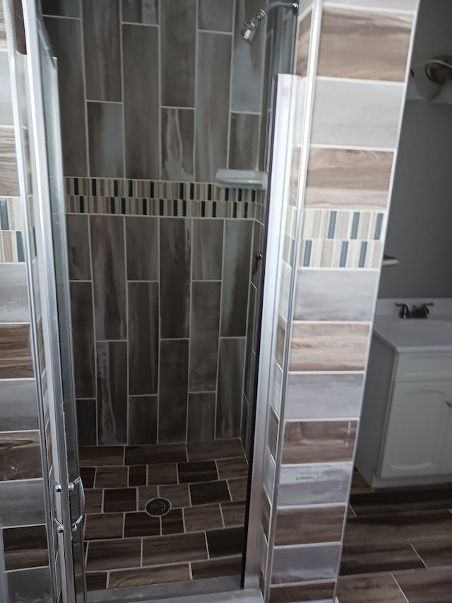 bathroom featuring a shower, hardwood / wood-style floors, and sink