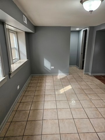 unfurnished room with light tile floors