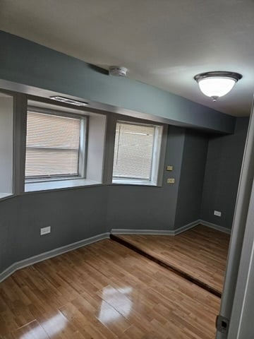 spare room featuring light wood-type flooring