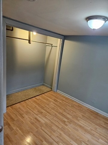 unfurnished bedroom featuring a closet and light wood-type flooring