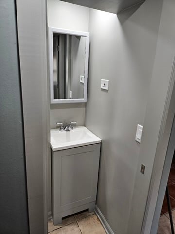 bathroom with vanity and tile flooring