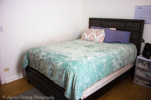 bedroom with dark wood-type flooring