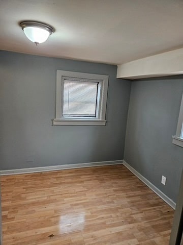 spare room featuring light wood-type flooring