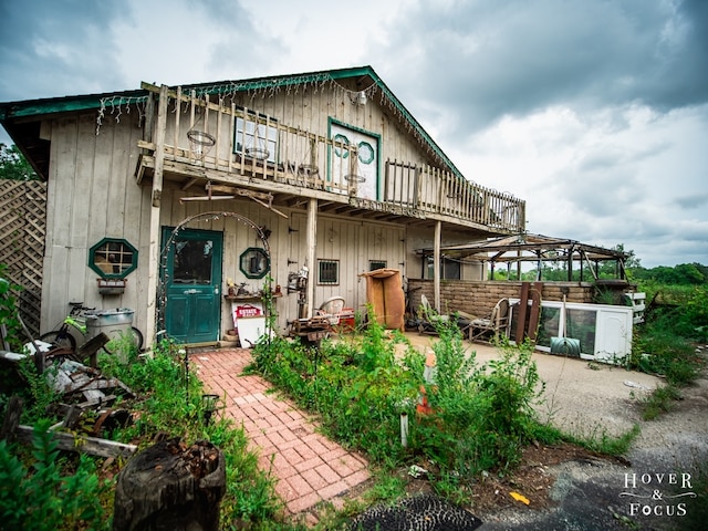 view of front facade featuring a patio and a balcony