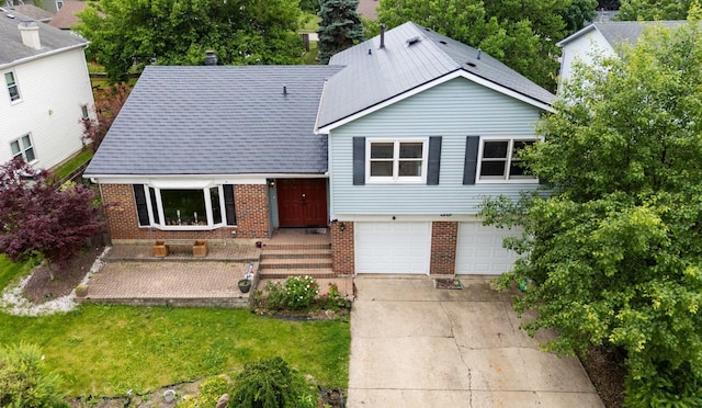 39 Mill Pond Dr, Glendale Heights, IL 60139 - split level home with brick siding, an attached garage, driveway, and a front yard