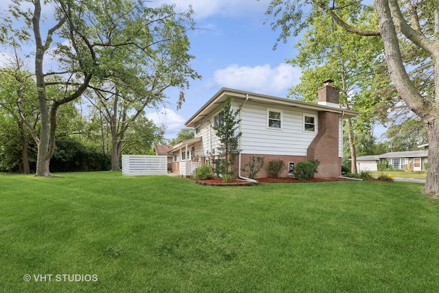 rear view of property with a lawn