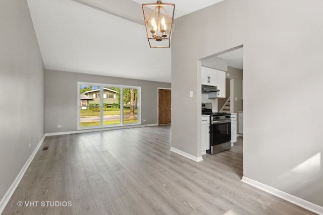 unfurnished living room with light hardwood / wood-style floors and a notable chandelier