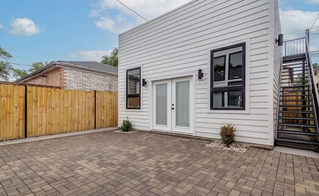 exterior space with stairs, fence, a patio, and french doors