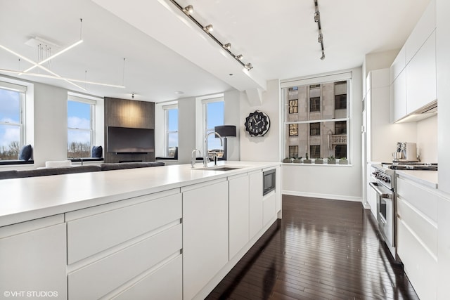 kitchen with white cabinetry, rail lighting, and a healthy amount of sunlight