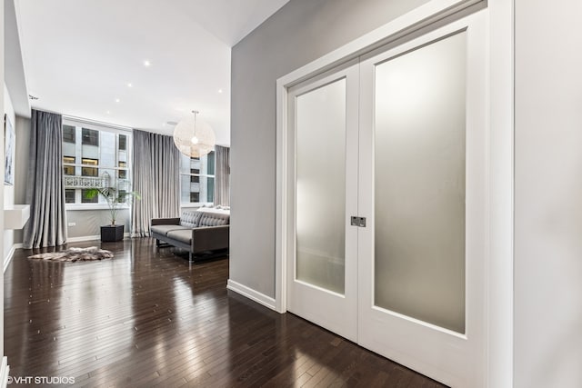 hall featuring dark hardwood / wood-style floors and french doors