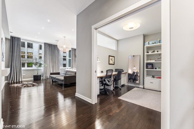 home office with dark hardwood / wood-style flooring