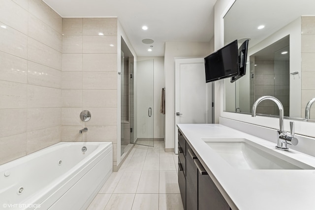 bathroom with tile flooring, vanity, and independent shower and bath