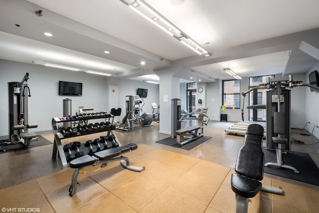 exercise room with light tile floors