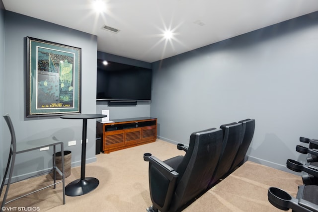 home theater room featuring light colored carpet