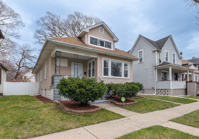 bungalow-style house featuring a porch and a front lawn