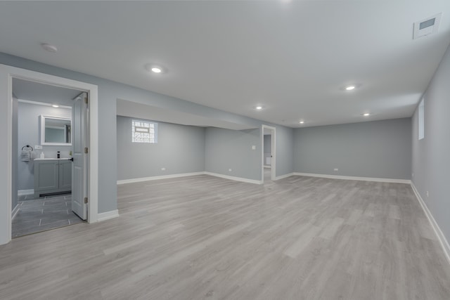 basement featuring light hardwood / wood-style flooring