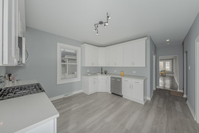 kitchen featuring sink, white cabinets, light hardwood / wood-style flooring, stainless steel appliances, and track lighting