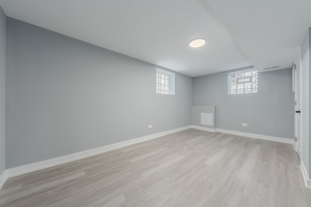 basement with light hardwood / wood-style floors