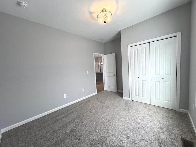 unfurnished bedroom with a closet and carpet floors