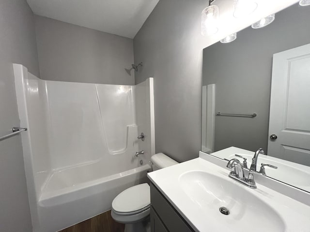 full bathroom featuring wood-type flooring, shower / bath combination, vanity, and toilet