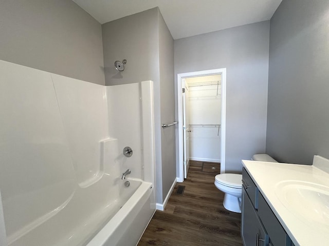 full bathroom with shower / tub combination, toilet, vanity, and hardwood / wood-style flooring