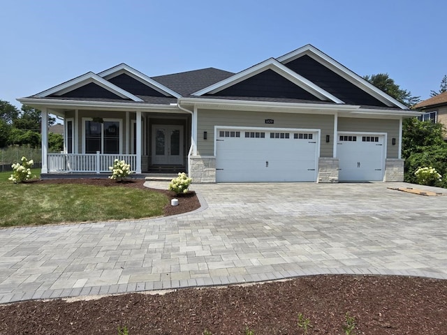 craftsman house with a garage and covered porch