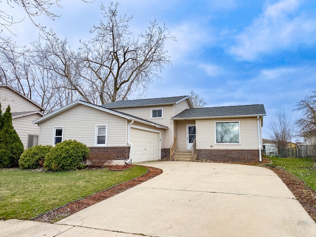 view of front of house with a front yard and a garage