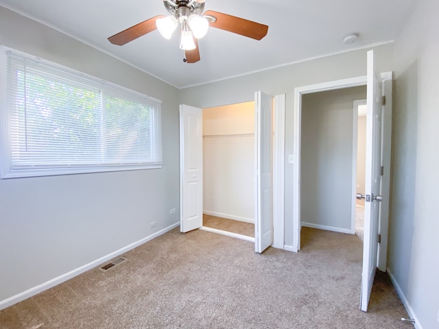 unfurnished bedroom with ceiling fan and light carpet