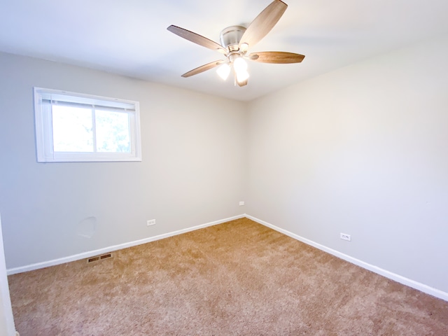 spare room with ceiling fan and carpet floors