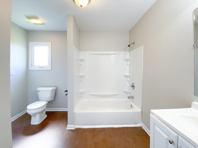 full bathroom with bathtub / shower combination, vanity, toilet, and hardwood / wood-style flooring