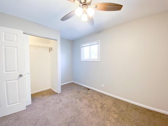 unfurnished bedroom with carpet flooring, a closet, and ceiling fan