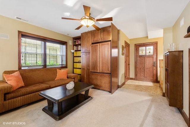 living room featuring ceiling fan and light carpet