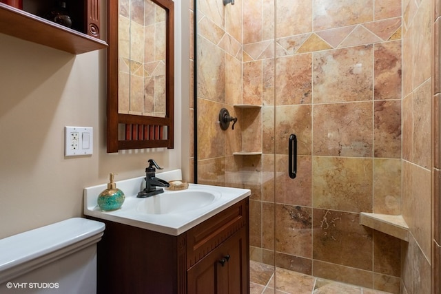 bathroom featuring a shower with shower door, oversized vanity, and toilet