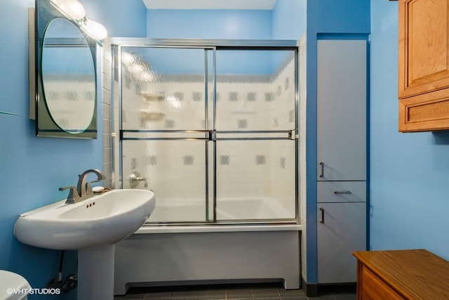 bathroom featuring tile flooring and toilet