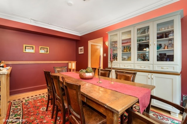 dining room featuring hardwood / wood-style floors and crown molding