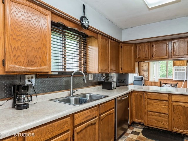 kitchen featuring dishwasher, light countertops, brown cabinetry, and a sink