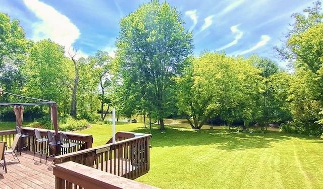 view of yard with a deck, a gazebo, and an outdoor bar