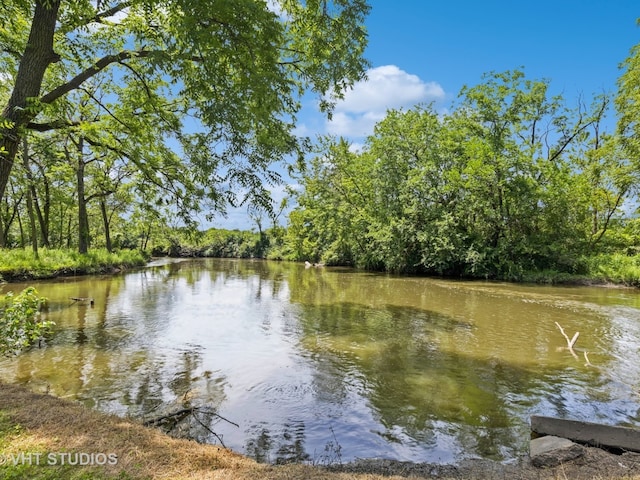 water view featuring a wooded view