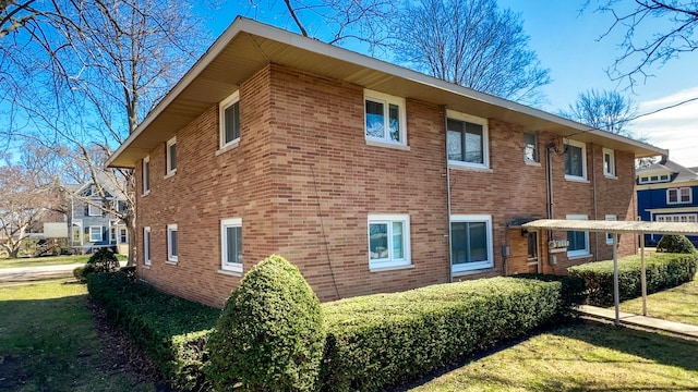 view of side of property with a lawn